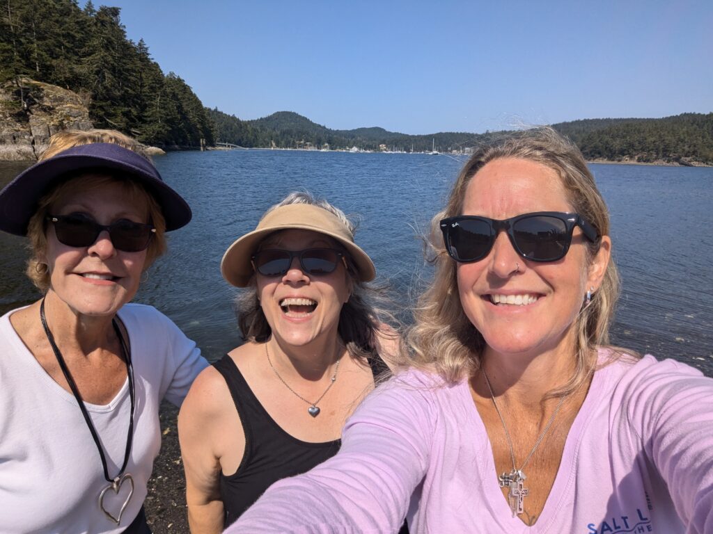 Sarah, Erin and me in a selfie with beautiful ocean water behind us.