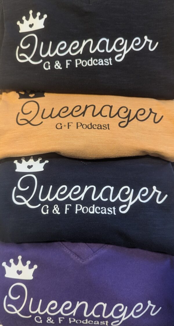 Four stacked Queenager Ts in black, mustard, navy and purple