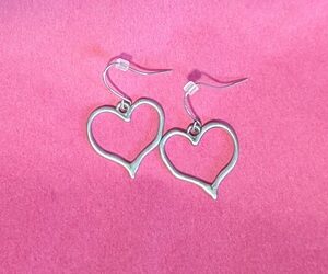 Heart earrings on a pink background